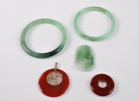 Lot 2572 - Two agate pendants and faux jade, the round...