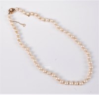 Lot 2584 - A cultured pearl necklace, the uniform...