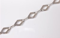 Lot 2586 - A 9ct white gold and diamond bracelet, the...