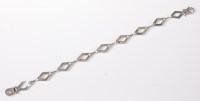 Lot 2586 - A 9ct white gold and diamond bracelet, the...