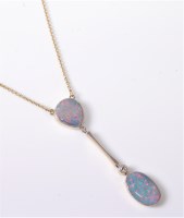 Lot 2590 - A 15ct and platinum opal and diamond pendant,...
