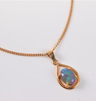 Lot 2591 - An opal necklace, the oval opal cabochon,...