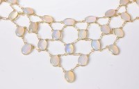 Lot 2592 - An opal necklace, the oval opal cabochons,...