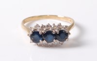 Lot 2604 - An 18ct sapphire and diamond ring, the three...