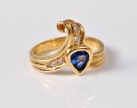 Lot 2605 - An 18ct sapphire and diamond ring, the pear...