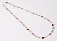 Lot 2609 - A multi gem set necklace, the oval faceted...