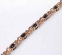 Lot 2614 - A 9ct sapphire and diamond bracelet, the oval...