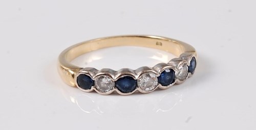 Lot 2627 - A sapphire and diamond half hoop ring, the...