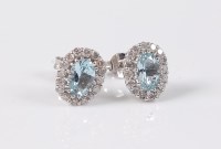Lot 2633 - A pair of aquamarine and diamond cluster...