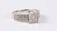 Lot 2634 - An 18ct diamond dress ring, the central round...