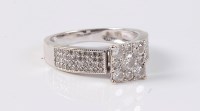 Lot 2634 - An 18ct diamond dress ring, the central round...