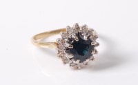 Lot 2637 - An 18ct sapphire and diamond cluster ring, the...