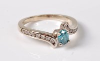 Lot 2641 - A treated blue and white diamond ring, the...