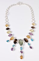 Lot 2645 - A multi gemset and silver necklace, the oval...
