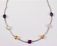 Lot 2650 - A multi gemset silver necklace, the seven oval...