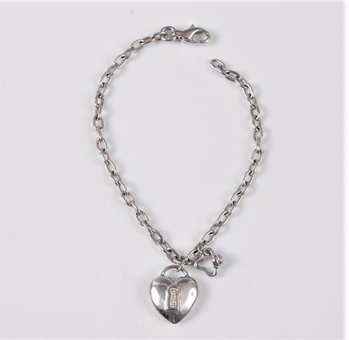 Lot 2652 - A diamond set heart shaped charm bracelet, the...