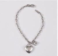 Lot 2652 - A diamond set heart shaped charm bracelet, the...