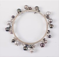 Lot 2653 - A silver and cultured pearl bangle by Dower &...