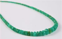 Lot 2657 - An emerald bead necklace, the faceted...
