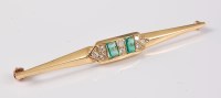 Lot 2661 - An emerald and diamond bar brooch, the two...