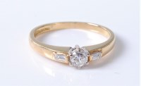 Lot 2688 - An 18ct three stone diamond ring, the central...
