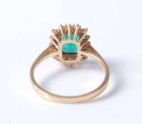 Lot 2218 - An 18ct emerald and diamond cluster ring, the...