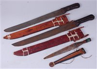 Lot 66 - A pair of African tribal machetes, each having...