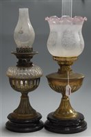 Lot 23 - An early 20th century brass pedestal oil lamp,...