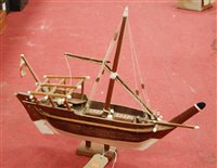 Lot 16 - A scratch-built wooden model of a sailboat