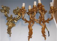 Lot 83 - A pair of Rococo style three branch gilt metal...