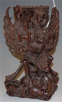 Lot 128 - A carved rosewood mythological figure group, h....