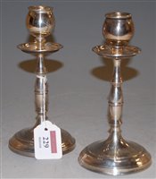 Lot 229 - A pair of George V silver table candlesticks...