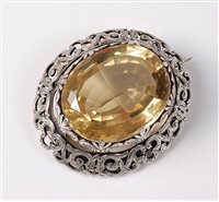 Lot 2331 - A citrine cairngorm brooch, the large oval...