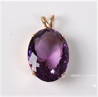 Lot 2323 - An amethyst pendant, the oval faceted amethyst...
