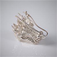 Lot 2672 - A silver dragon head ring, the large stylised...