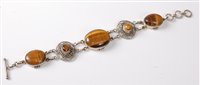 Lot 2504 - A tigers eye and silver bracelet, the central...