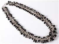 Lot 2572 - A black onyx and silver necklace, the...