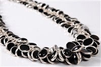Lot 2572 - A black onyx and silver necklace, the...
