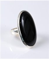 Lot 2574 - A black onyx ring, the large oval black onyx...