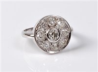 Lot 2308 - An 18ct diamond target ring, the central round...