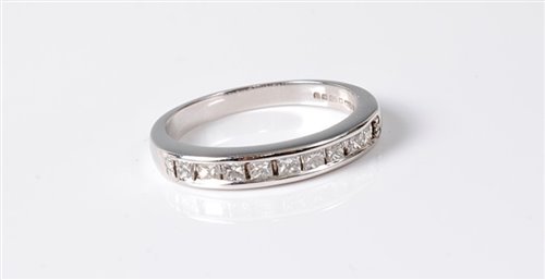 Lot 2579 - An 18ct diamond half hoop eternity ring, the...