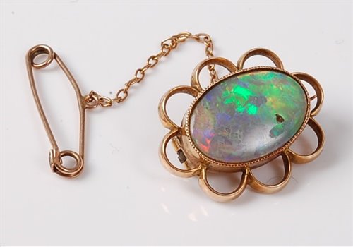 Lot 2237 - A 15ct opal brooch, the oval opal cabochon in...