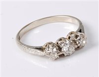 Lot 2194 - An 18ct three stone diamond ring, the three...