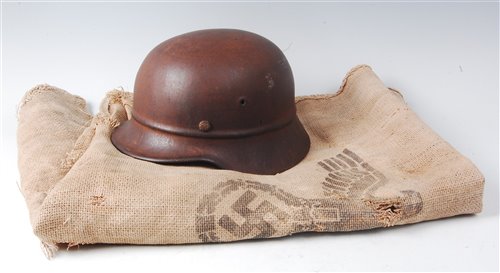 Lot 83 - A WW II German beaded pattern steel helmet,...