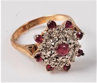 Lot 320 - An 18ct ruby and diamond cluster ring, the...
