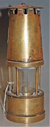 Lot 42 - A brass miners safety lamp by the Protector...