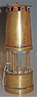 Lot 41 - A brass miners safety lamp by the Protector...