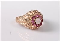 Lot 366 - A 9ct opal and ruby cluster ring, the central...