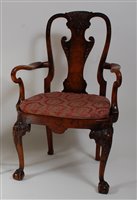 Lot 2660 - A walnut and figured walnut elbow chair, in...