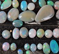 Lot 2212 - A quantity of loose opal cabochons, all of...